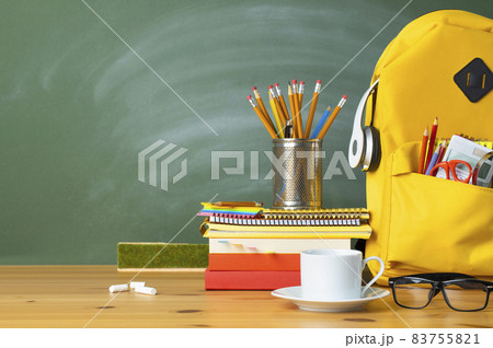 Backpack, textbooks, stationery and school supplies on wooden desk. Backpack, textbooks, stationery and school supplies on wooden desk. 83755821