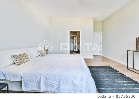 Bedroom with light bed linen on the bed 83756530