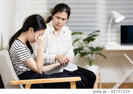 Stressed asian teenager girl crying,thinking about life problems at home,sad teenage female having psychological trouble with depressive symptoms feel despair,depression,sorrow,mental disorder concept 83757334