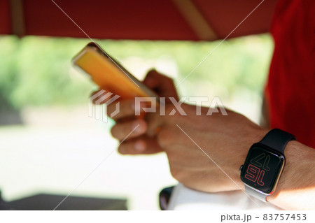the man looks at the phone the man looks at the phone 83757453