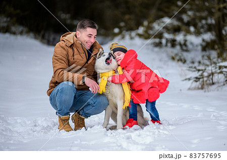 Happy father and little daughter and husky dog in winter forest walking in winter. Happy father and little daughter and husky dog in winter forest walking in winter. 83757695