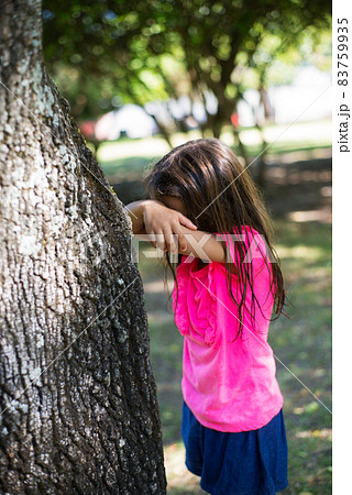Long-haired little girl playing in park 83759935