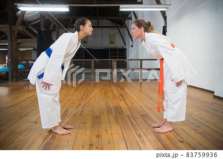 Dedicated young women starting karate training Dedicated young women starting karate training 83759936
