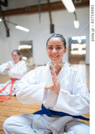 Joyful young Caucasian girl posing in karate position after class 83759985