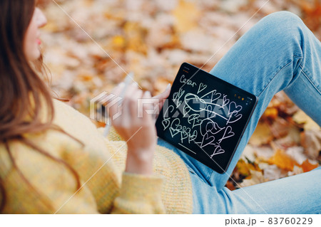 Young woman model in autumn park with yellow foliage maple leaves. Fall season fashion. Young woman model in autumn park with yellow foliage maple leaves. Fall season fashion. 83760229