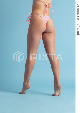 Cropped image of authentic female body in white underwear isolated on light blue studio background. Natural beauty concept. Cropped image of authentic female body in white underwear isolated on light blue studio background. Natural beauty concept. 83760632