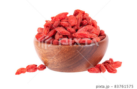 Chinese wolfberries in wooden bowl, isolated on white background. Heap of dried goji berry. 83761575