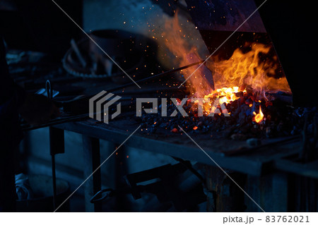 Piece of metal heating inside fireplace at forge Piece of metal heating inside fireplace at forge 83762021