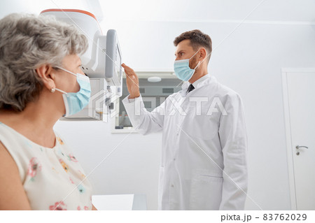 Radiologist touching screen of modern equipment starting scanning..  83762029