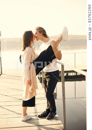 Beautiful couple spend time on a summer park Beautiful couple spend time on a summer park 83762260