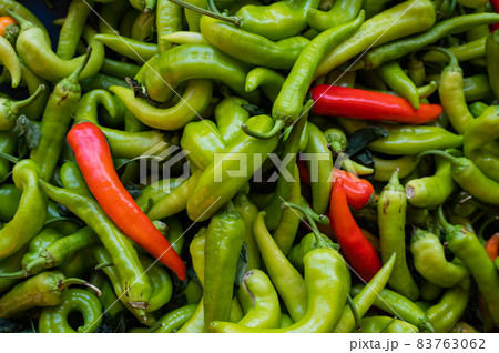Close-up on a shelf with green and red peppers in the market. Close-up on a shelf with green and red peppers in the market. 83763062