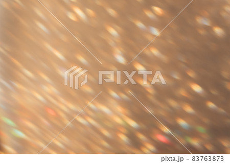 Blur light background. Bokeh sparks. Disco rays reflection. Party gleam. Defocused colorful orange blue flecks on golden abstract overlay. 83763873