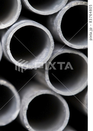 Metal profile pipe of round section in packs at the warehouse of metal products Metal profile pipe of round section in packs at the warehouse of metal products 83764805