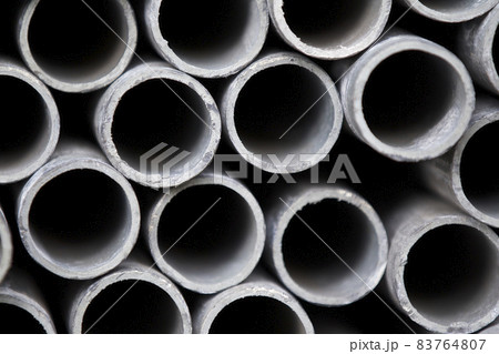 Metal profile pipe of round section in packs at the warehouse of metal products Metal profile pipe of round section in packs at the warehouse of metal products 83764807
