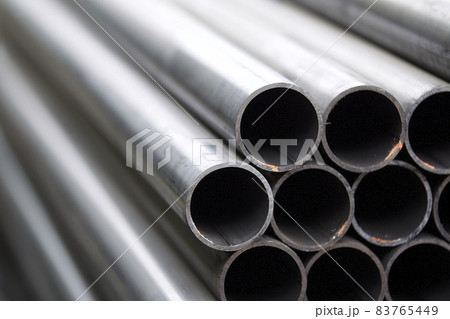 Metal profile pipe of round section in packs at the warehouse of metal products Metal profile pipe of round section in packs at the warehouse of metal products 83765449
