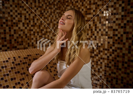 A blonde cute young woman in a hammam looking relaxed A blonde cute young woman in a hammam looking relaxed 83765719