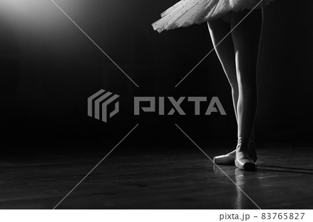 Ballet dancer's legs in pointe shoes on theater stage. Ballerina standing in 3 third position on Ballet dancer's legs in pointe shoes on theater stage. Ballerina standing in 3 third position on 83765827