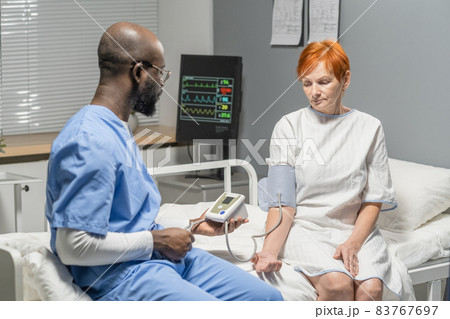 Doctor measuring the pressure of patient 83767697