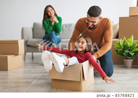 Happy arab family playing, celebrating relocation in new house 83768825