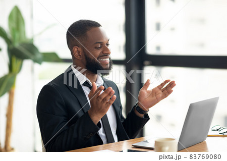 Black man having video call using laptop and talking 83769080