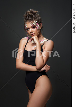 Beautiful caucasian woman with perfect body and flowers 83770003