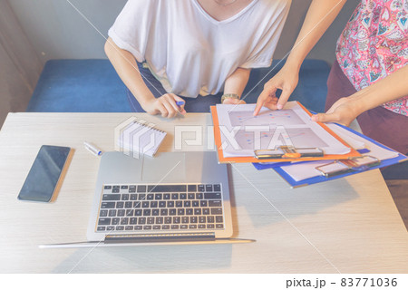 Close up photo of woman hand pointing at chart document 83771036