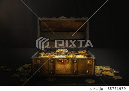 Heap of coins in small wooden chest 83771979