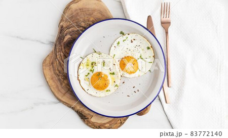 top view breakfast fried eggs plate with cutlery. High quality beautiful photo concept 83772140