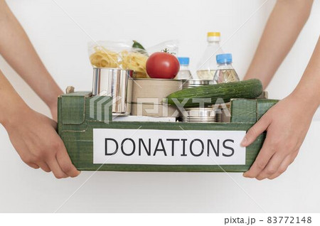 volunteers holding box filled with food donation. High quality beautiful photo concept volunteers holding box filled with food donation. High quality beautiful photo concept 83772148
