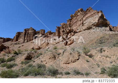 Canyon sunlit view with rocks and a pronounced texture of a yellowish stone Canyon sunlit view with rocks and a pronounced texture of a yellowish stone 83772335
