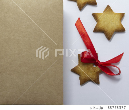 Gingerbread cookies. Natural paper background and white background. Christmas baking background. New Year theme. Merry Christmas and Happy New Year Holidays greeting card, frame, banner, copy space 83773577