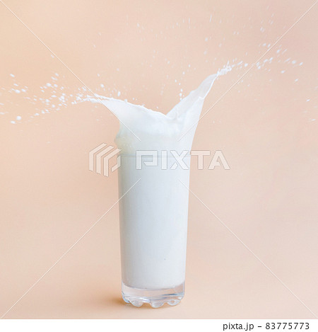 pouring milk out glass. High quality beautiful photo concept pouring milk out glass. High quality beautiful photo concept 83775773