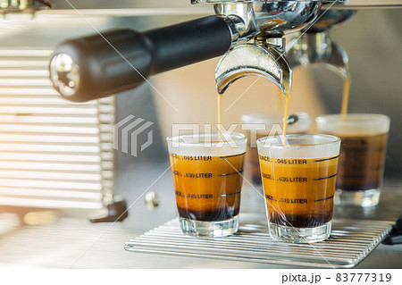 Preparing coffee espresso in automatic coffee machine in cafe 83777319