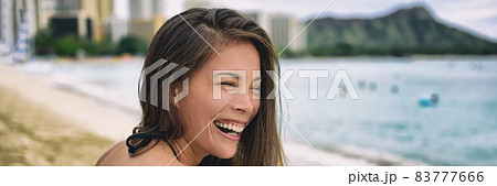 Happy Asian woman laughing smiling young adulthood lifestyle - Hawaii summer travel happiness banner panorama background. 83777666