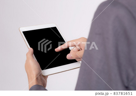 Closeup young asian business man showing and presenting tablet computer with blank screen. 83781651