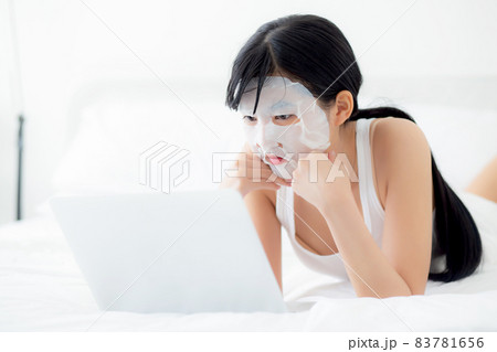 Beauty of young asian woman with learning makeup with lipstick on mouth watching laptop. Beauty of young asian woman with learning makeup with lipstick on mouth watching laptop. 83781656