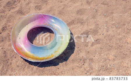 Swimming Ring. Children Baby Swimming Lap. Inflatable swim ring on sand beach Swimming Ring. Children Baby Swimming Lap. Inflatable swim ring on sand beach 83783733