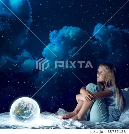 Girl in her bed and glowing globe 83785128