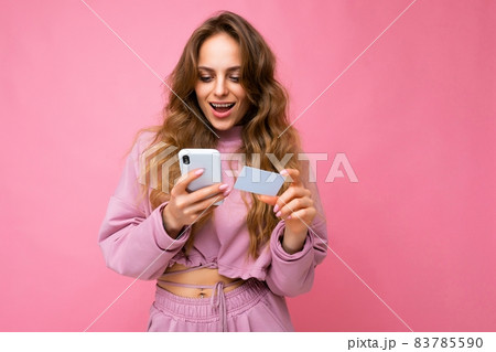Photo shot of young beautiful attractive cute surprised happy curly blonde woman wearing trendy and 83785590