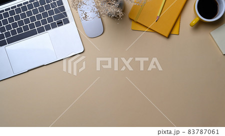 Female workspace with laptop computer, coffee cup and notebook. Female workspace with laptop computer, coffee cup and notebook. 83787061