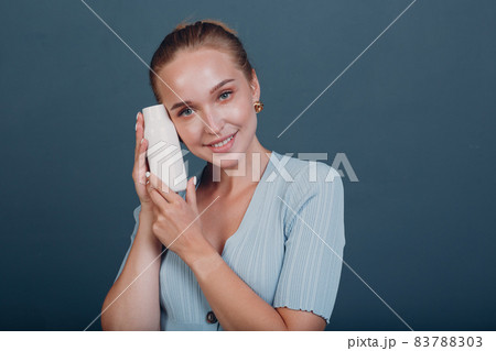 Pretty young woman hold bottle with empty space. Shampoo and conditioner. Pretty young woman hold bottle with empty space. Shampoo and conditioner. 83788303