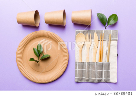 set of empty reusable disposable eco-friendly plates, cups, utensils on light white colored table background. top view. Biodegradable craft dishes. Recycling concept. Close-up set of empty reusable disposable eco-friendly plates, cups, utensils on light white colored table background. top view. Biodegradable craft dishes. Recycling concept. Close-up 83789401