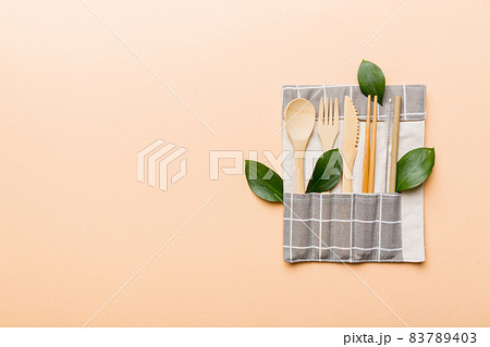 Eco friendly reusable recyclable white eco bag with kitchenware on Colored background. Concept zero waste Eco friendly reusable recyclable white eco bag with kitchenware on Colored background. Concept zero waste 83789403