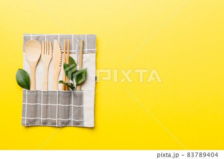 Eco friendly reusable recyclable white eco bag with kitchenware on Colored background. Concept zero waste Eco friendly reusable recyclable white eco bag with kitchenware on Colored background. Concept zero waste 83789404