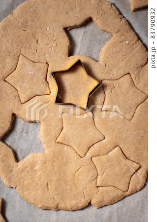 Baking homemade Christmas gingerbread cookies. top view of holiday background with dough spices and fir tree. Baking homemade Christmas gingerbread cookies. top view of holiday background with dough spices and fir tree. 83790932