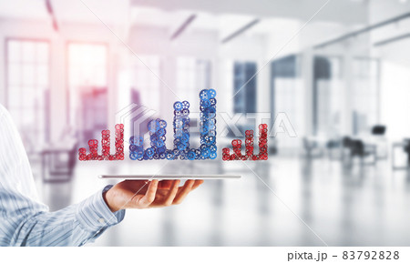 Close of businessman holding tablet pc with progressing graph icon 83792828