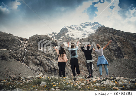 A group of friends climbed high in the mountains A group of friends climbed high in the mountains 83793892