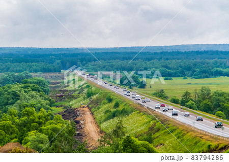 The road that goes into the distance, a view from above. The view from the height of the road with cars The road that goes into the distance, a view from above. The view from the height of the road with cars 83794286
