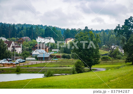 View from a height of cottages by the river. A view from above on a panorama of cottages by the river. Mountain landscape View from a height of cottages by the river. A view from above on a panorama of cottages by the river. Mountain landscape 83794287