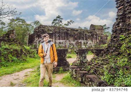 Man tourist in Temple ruin of the My Son complex, Vietnam. Vietnam opens to tourists again after quarantine Coronovirus COVID 19 Man tourist in Temple ruin of the My Son complex, Vietnam. Vietnam opens to tourists again after quarantine Coronovirus COVID 19 83794746